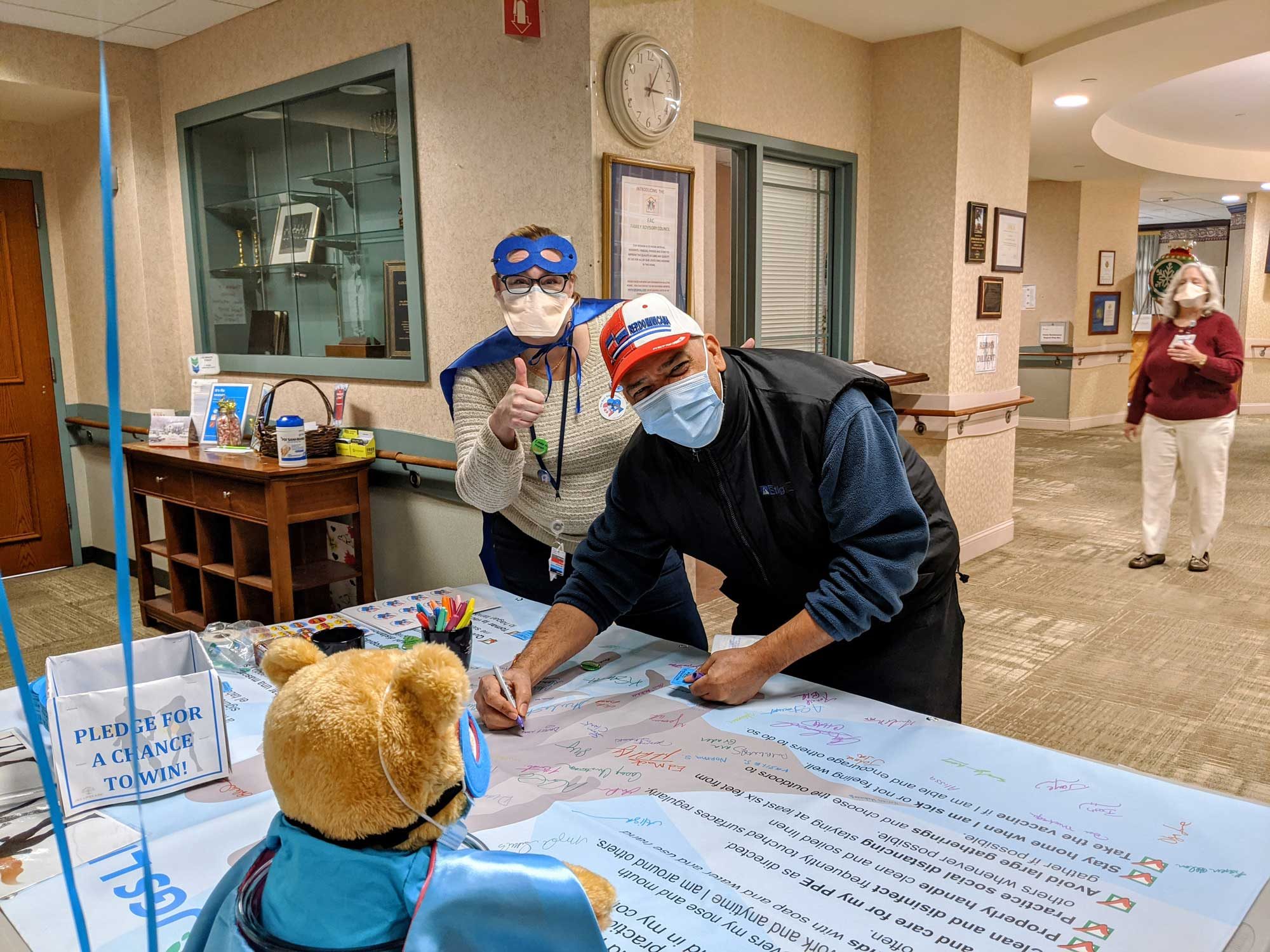 JGS Lifecare staff signing the Superhero Pledge