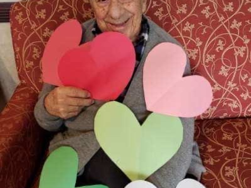 Armen with cut out hearts during COVID
