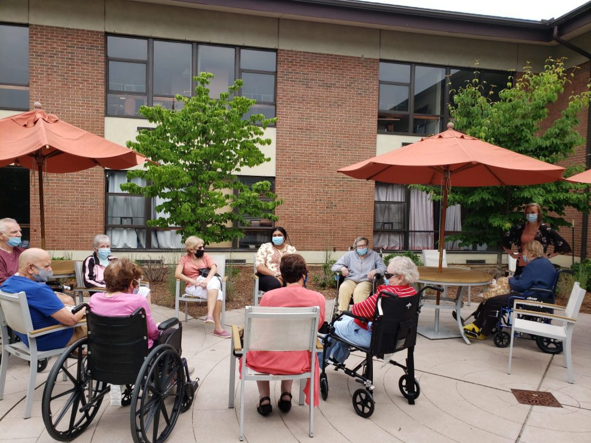 Residents of JNH enjoying a summer day on the patio outside Michael's Cafe.