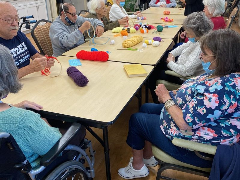 Residents make a dreamcatcher craft.