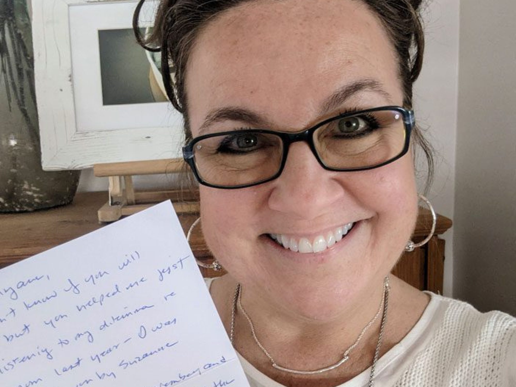 Mary Anne Schelb holding a thank you note.