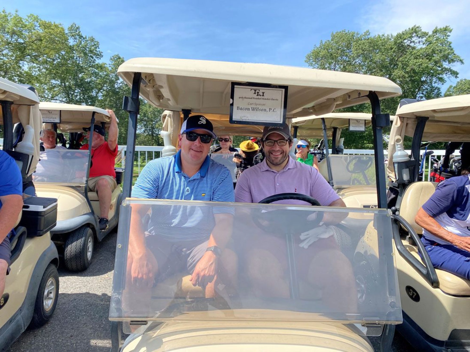 Rob Whitten and Adam Berman in a golf cart