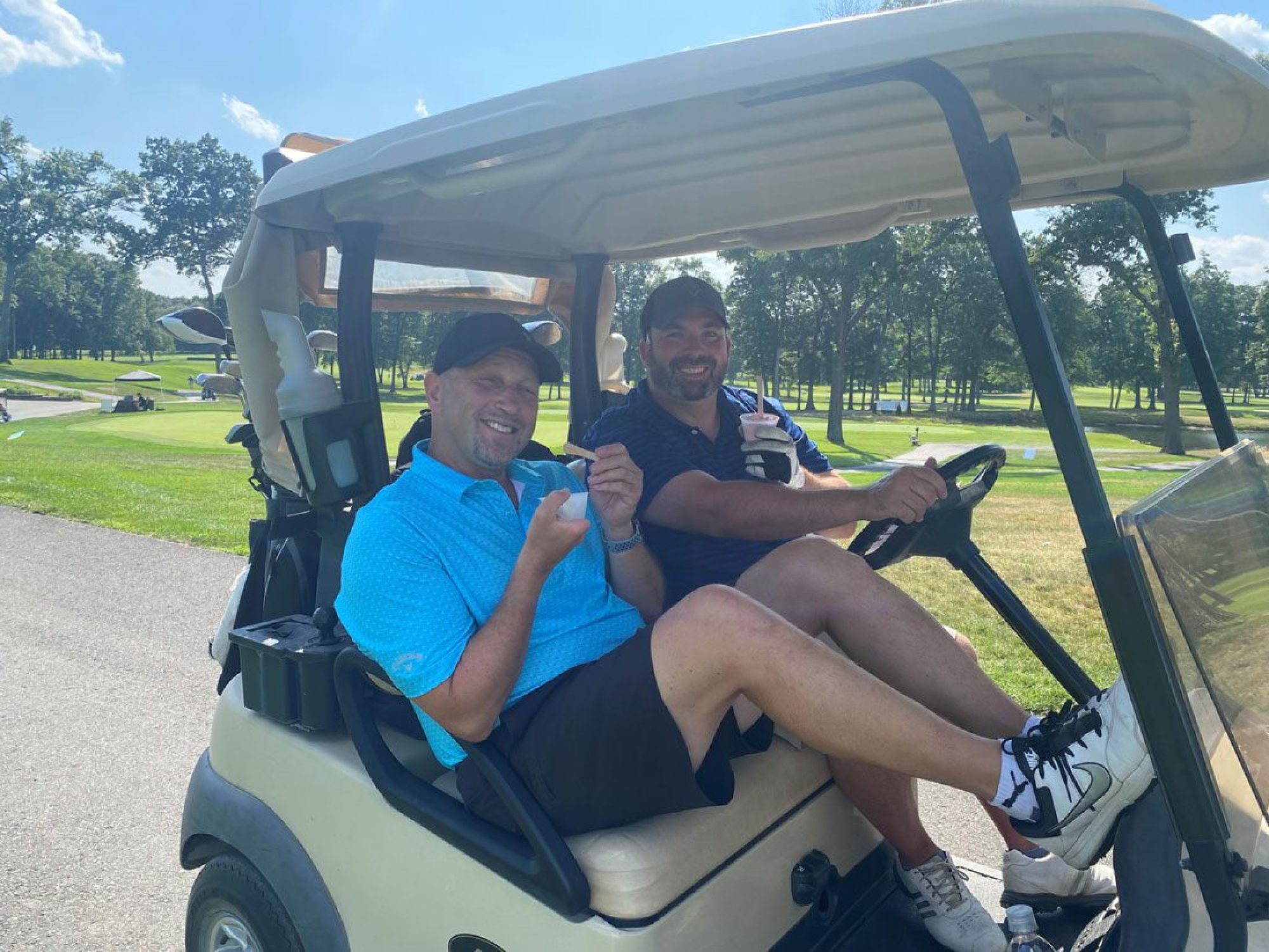 Josh Weiss and Eric Castonguay in a golf cart