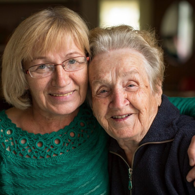 A portrait of an adult woman with her elderly mother