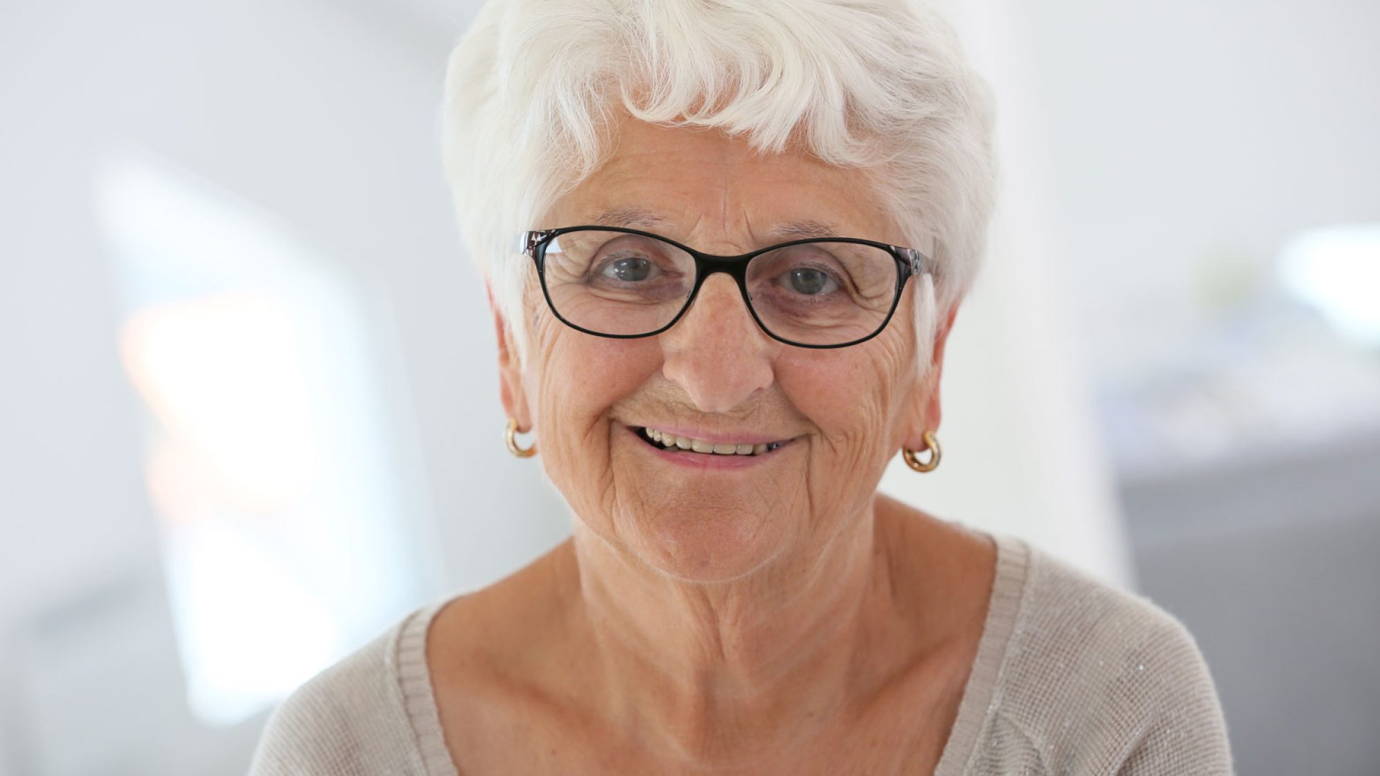Portrait of an older woman wearing grey