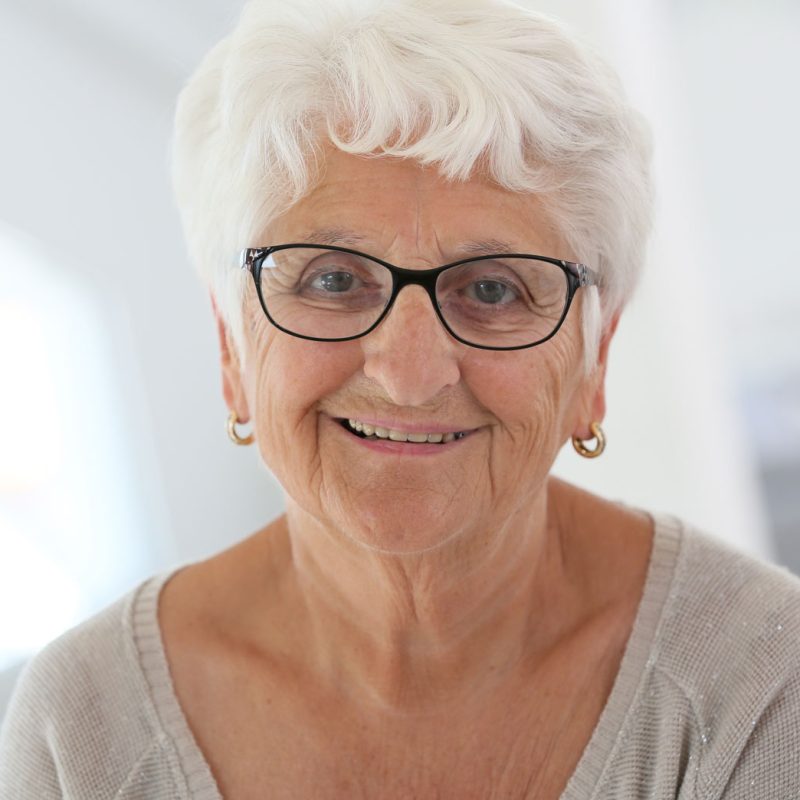 Portrait of an older woman wearing grey