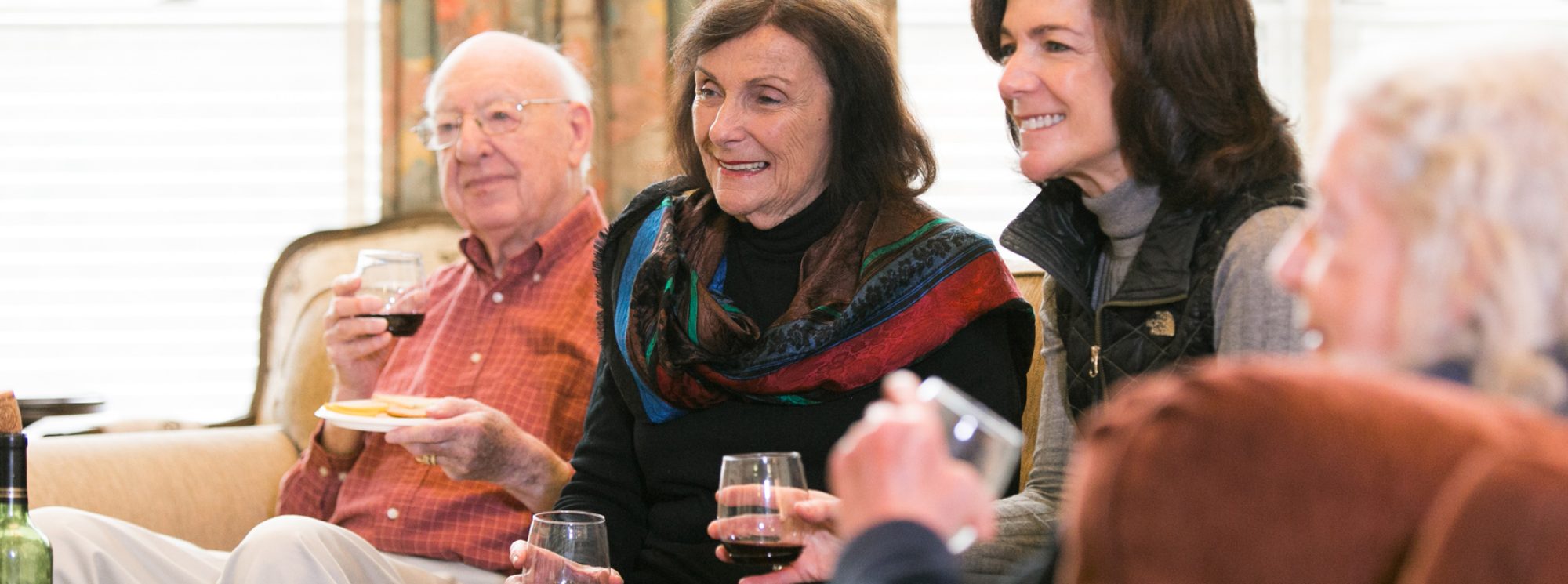 Residents enjoy time together while drinking wine.