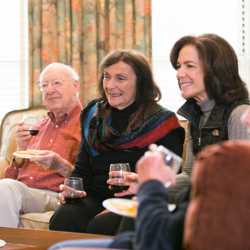 Residents enjoy time together while drinking wine.